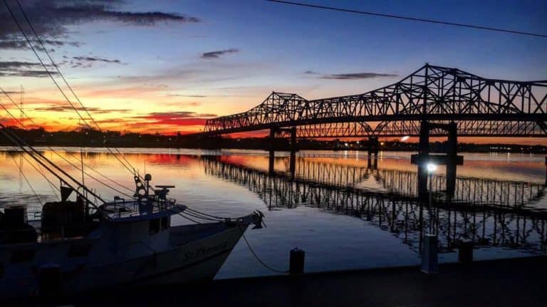 Louisiana Bridges on the Atchafalaya River at dusk with shrimp boat