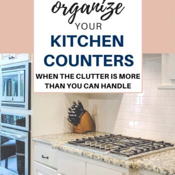 A tidy white kitchen with granite counters, a built-in oven, gas stovetop, and a knife block. Overlaid text reads: How to organize your kitchen counters when the clutter is more than you can handle.
