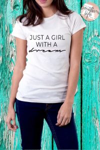 Just a Girl with a dream tee designed by It's a Southern Life Y'all. Available in white, pink, silver, heather grey, and heather blue.