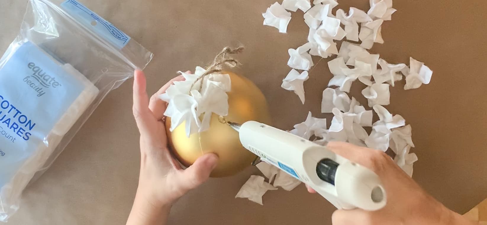 Gluing cotton shapes to ornament.