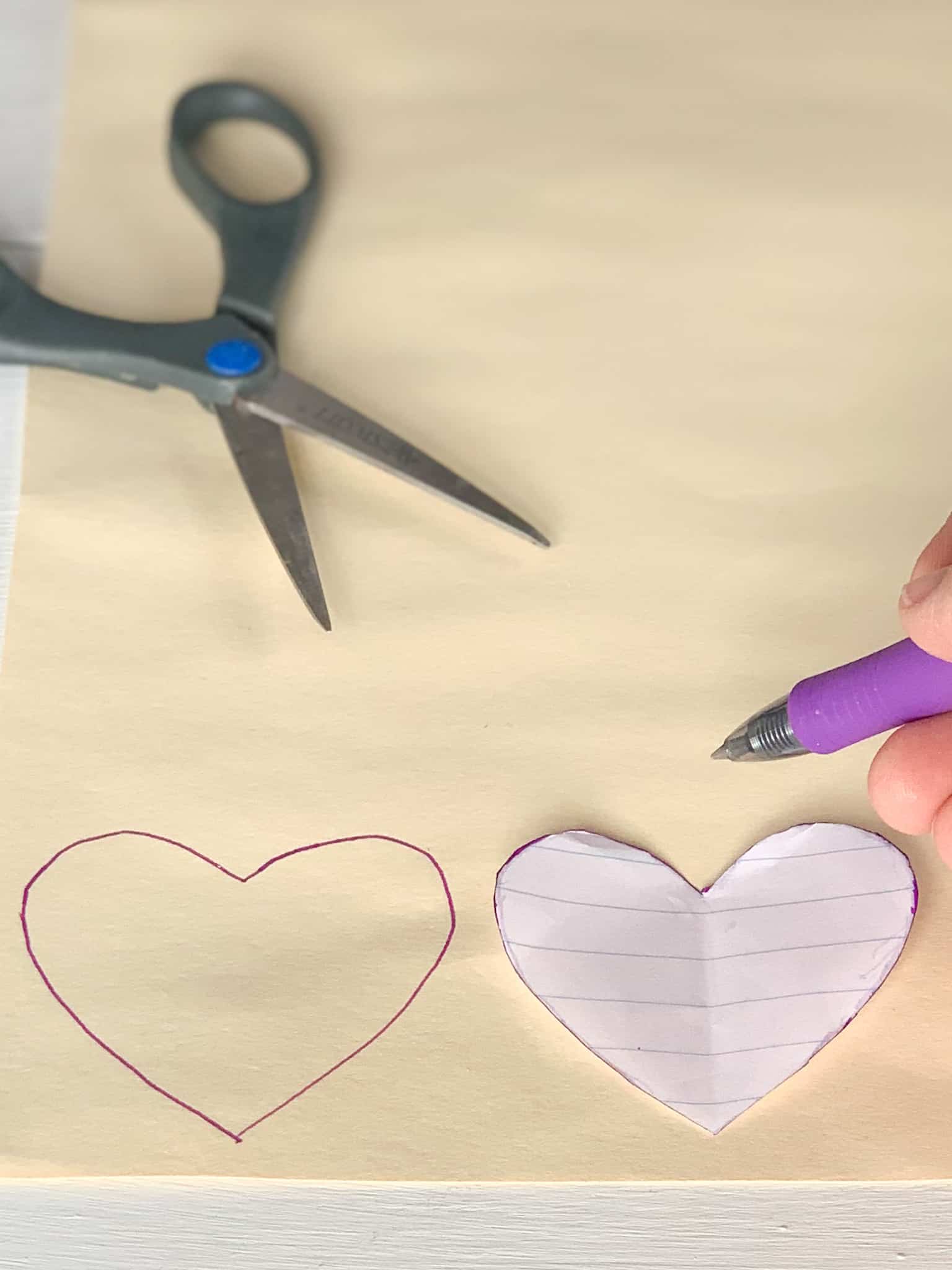 Tracing hearts onto file folder. 