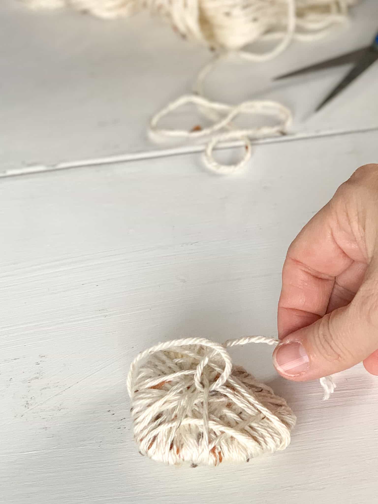 Cut end of yarn and secure by making a knot. 