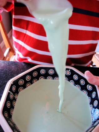 Pouring Oobleck into a bowl.