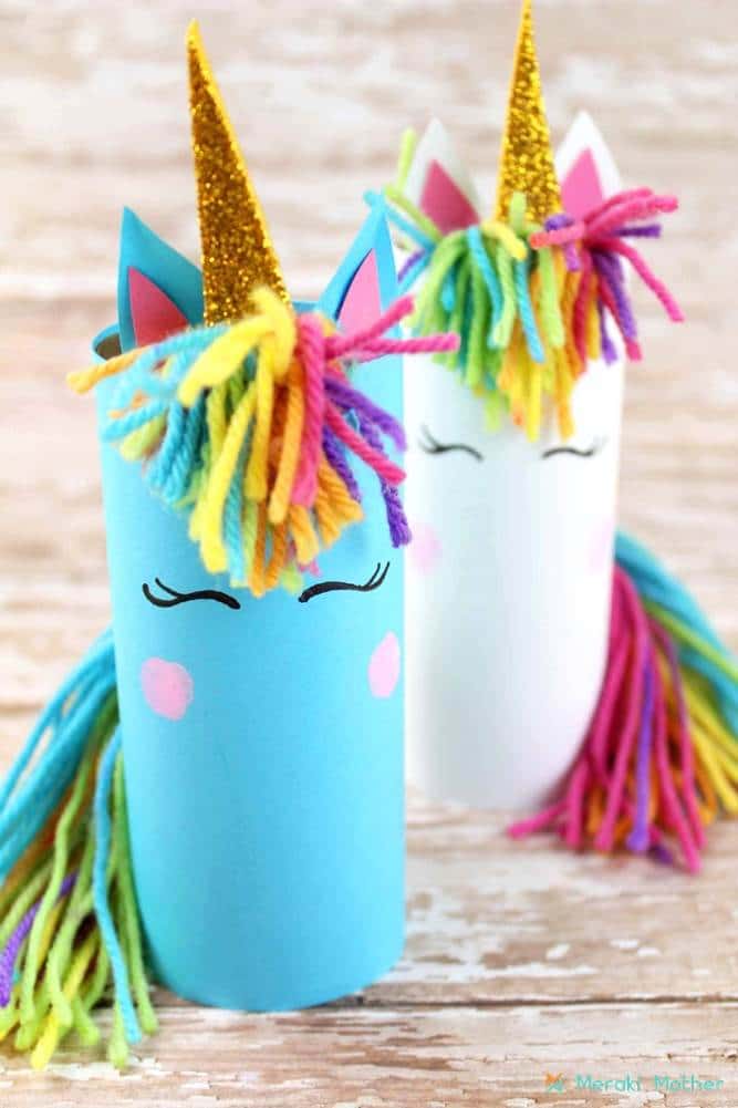 Two adorable unicorns made with toilet paper tubes and colorful yarn.
