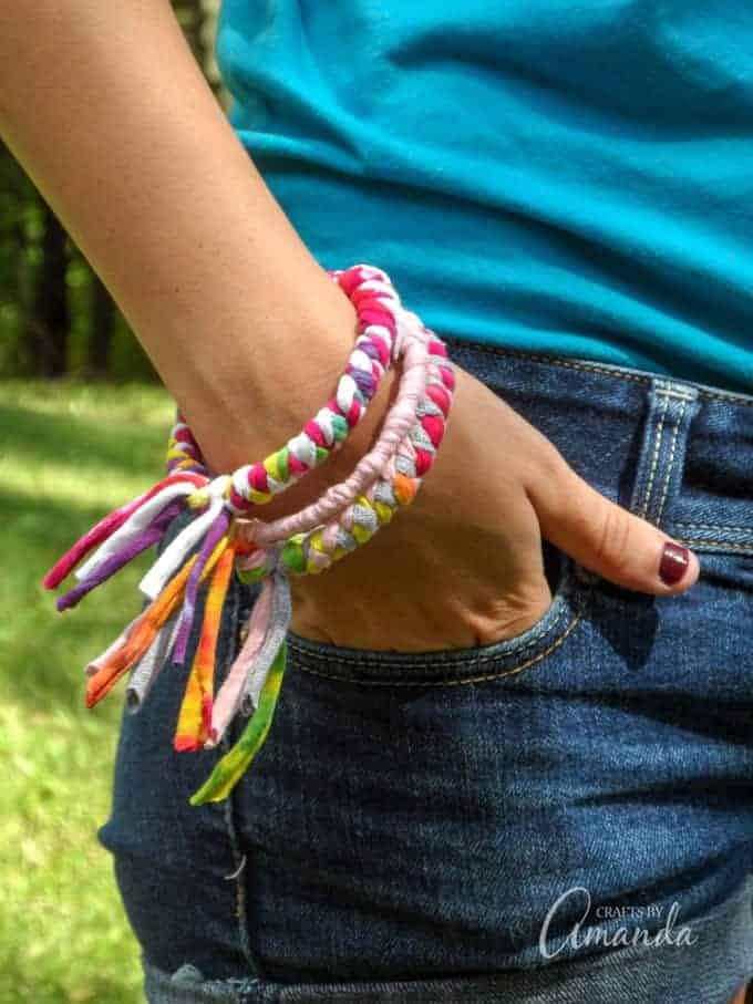Close up of recycled t-shirt bracelets on girl's wrist.