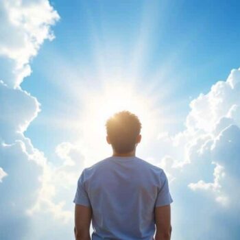 A person stands facing a bright sun surrounded by dramatic clouds, with rays of sunlight streaming through the sky, creating a sense of hope and contemplation.