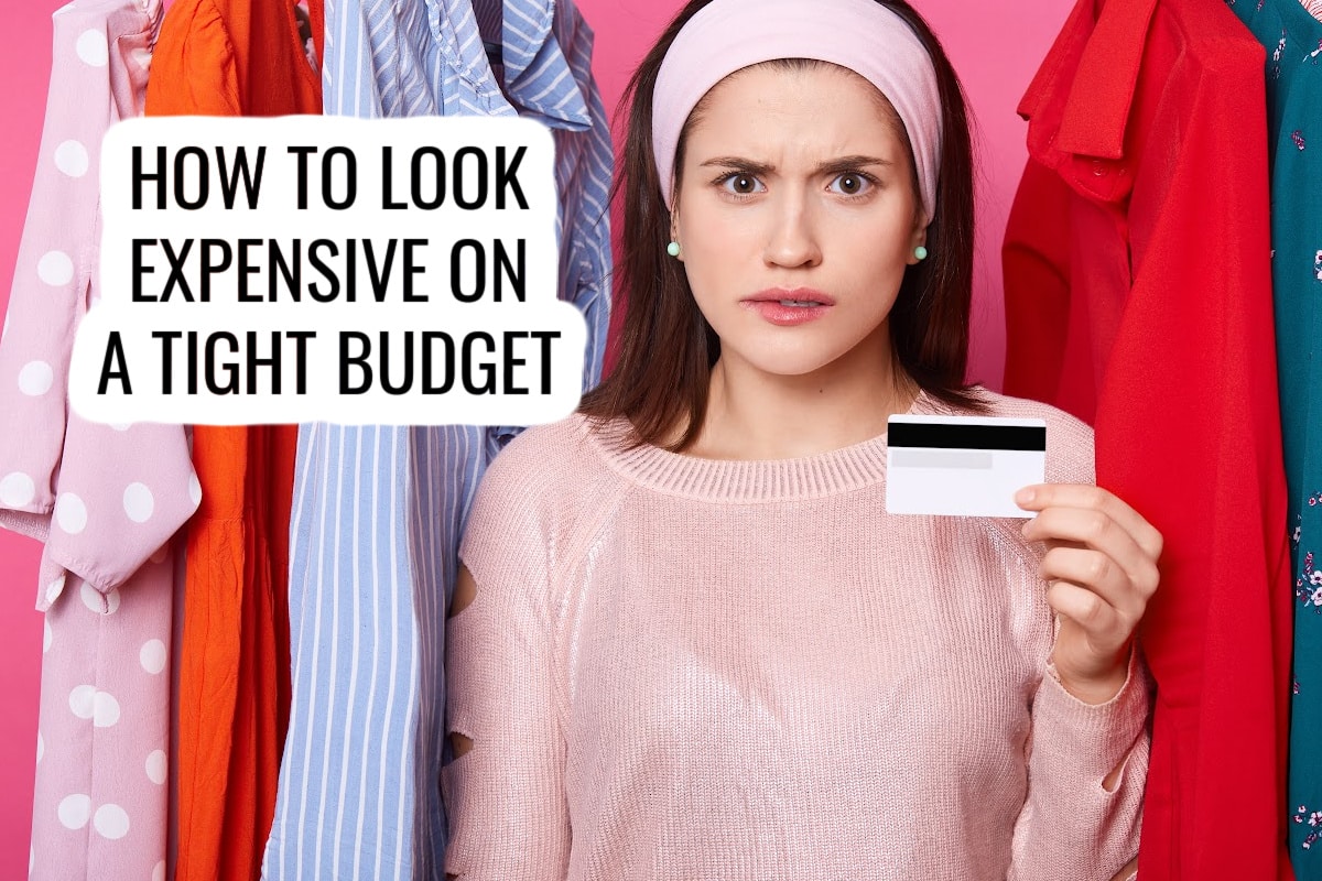 A young woman stands between colorful clothes, holding a credit card and looking concerned. Text on the image reads: “How to look expensive on a tight budget.”.