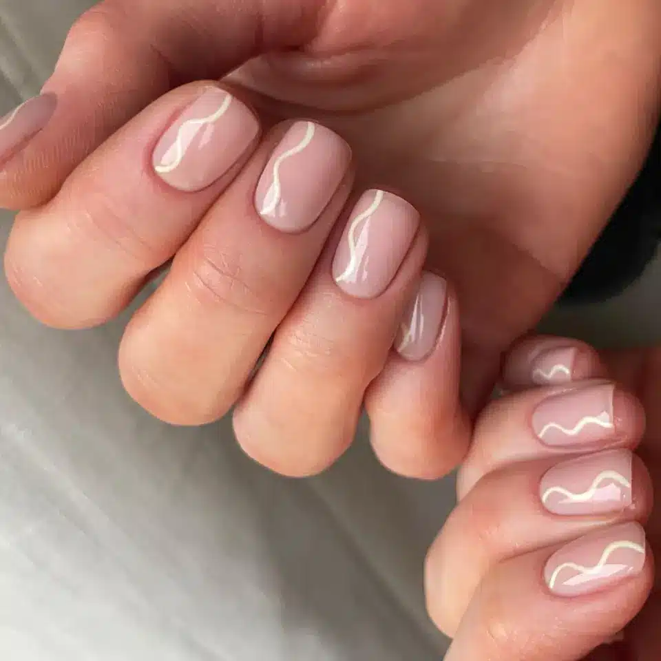 nude and white swirl engagement nails