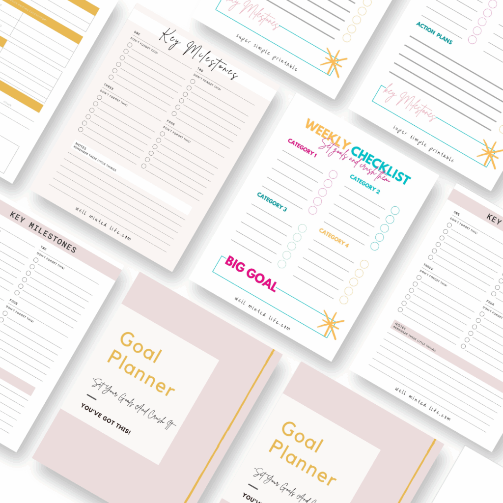 A flat lay of printable goal planner pages, including checklists, key milestones, action plans, and goal summaries with pastel pink, gold, and white designs arranged neatly on a white background.