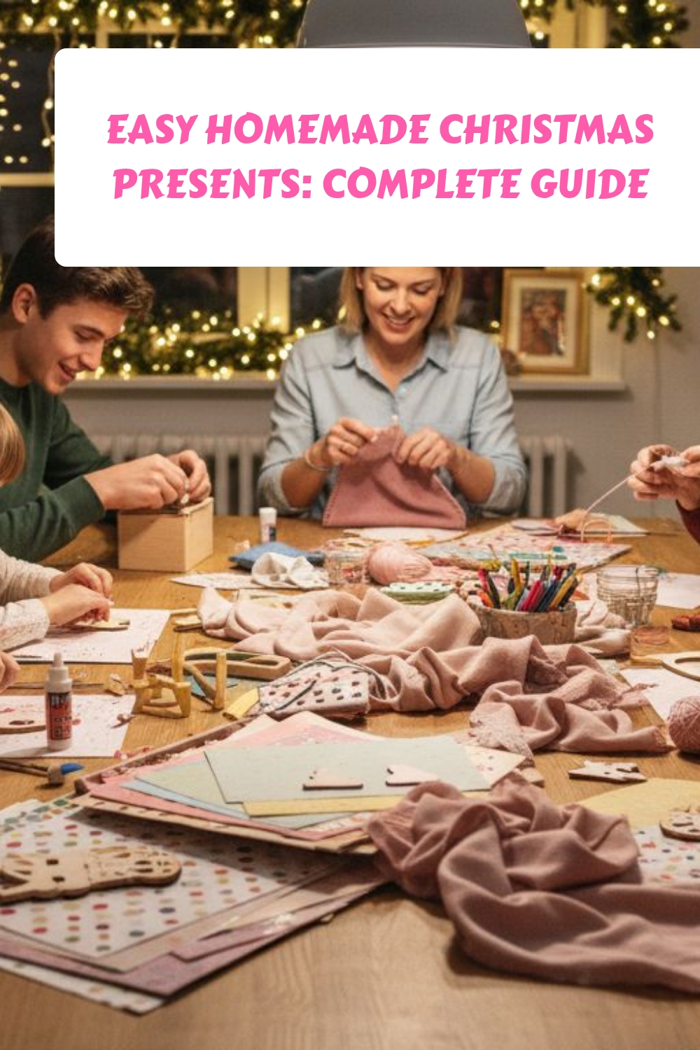 A family sits around a table filled with craft supplies, making homemade Christmas presents together. The room is decorated with string lights and a Christmas tree, creating a cozy holiday atmosphere. Text reads: Easy Homemade Christmas Presents: Complete Guide.