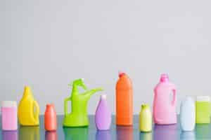 A vibrant assortment of cleaning product containers arranged on a reflective surface, perfect for household sanitation themes.