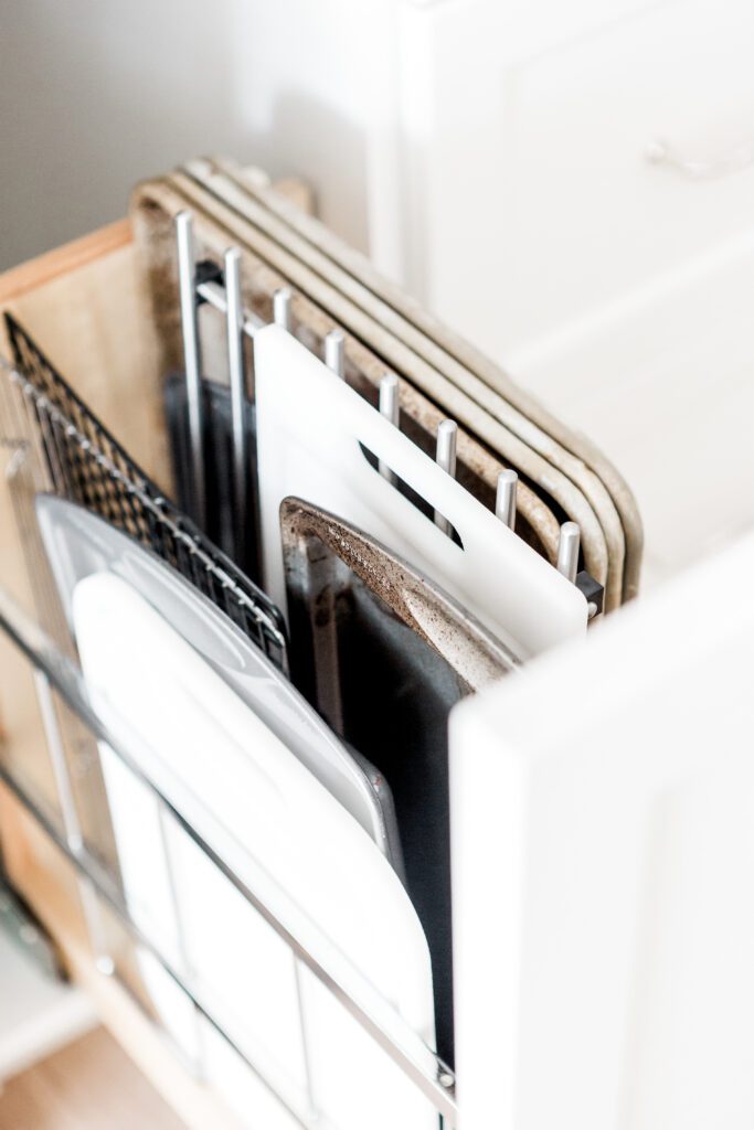 Kitchen organization tips - wire racks and baking trays stored in a pull out cupboard