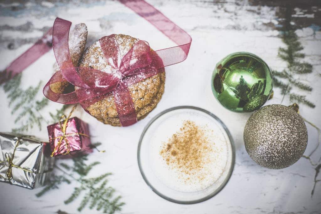 A cozy winter scene with Christmas cookies, milk, and ornaments for the perfect holiday atmosphere.