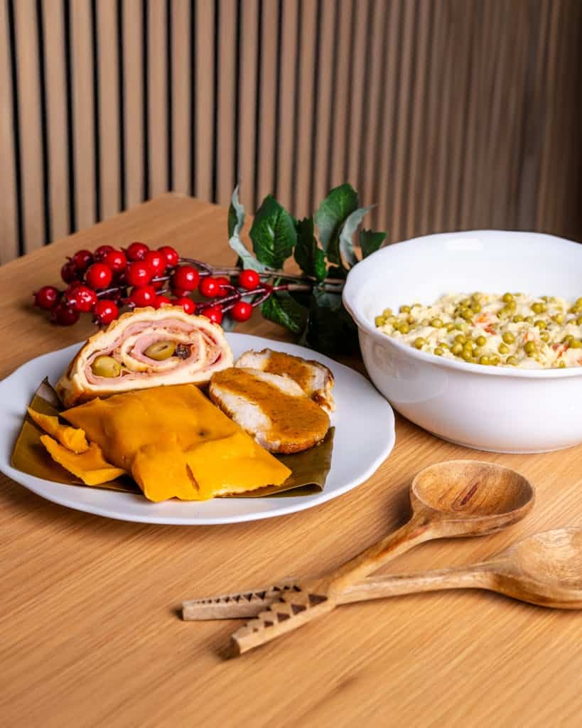 Festive Venezuelan Christmas meal with hallacas, pan de jamon, and ensalada.