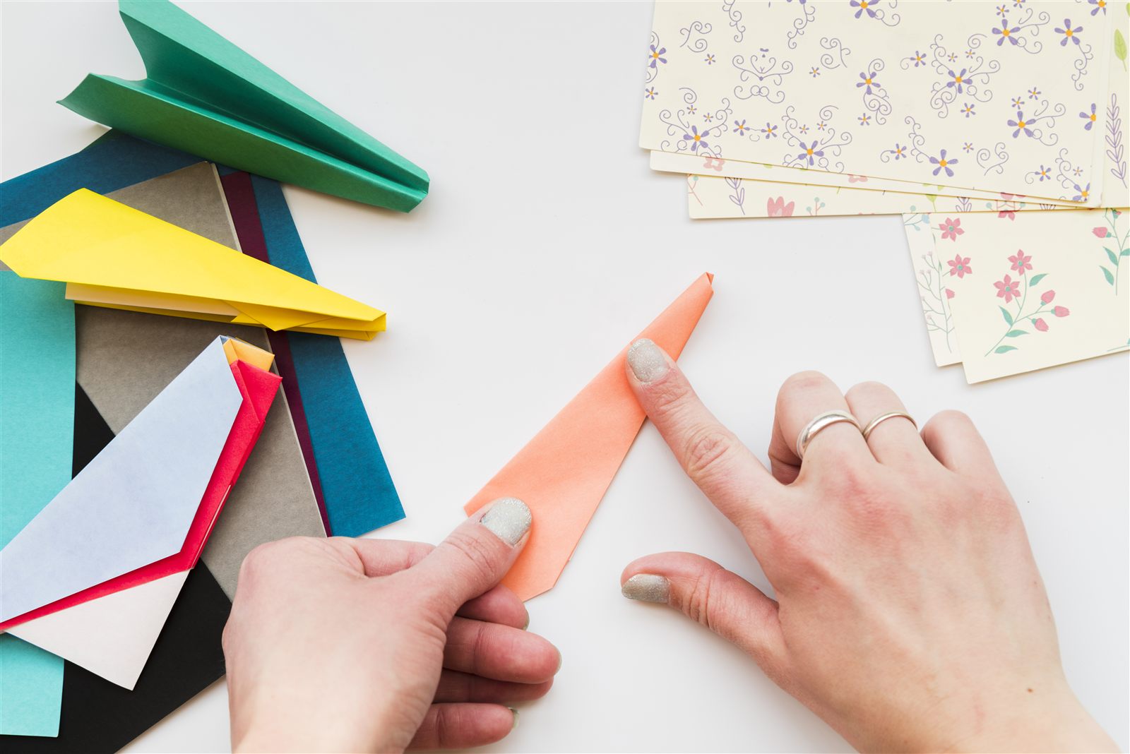Paper airplane craft for kids - folding colorful paper airplanes at the table