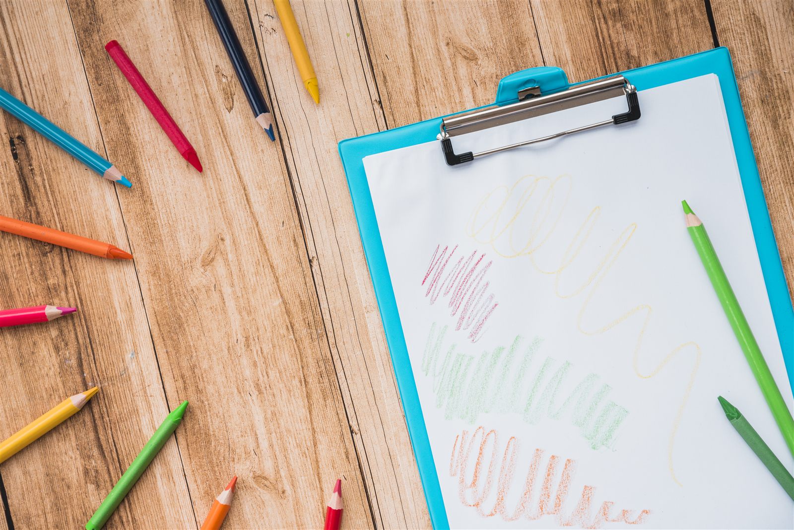 Road trip activity printables on a clipboard with colored pencils