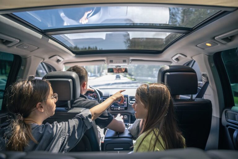 Printable road trip activities for kids - little girls playing in the backseat on a family trip