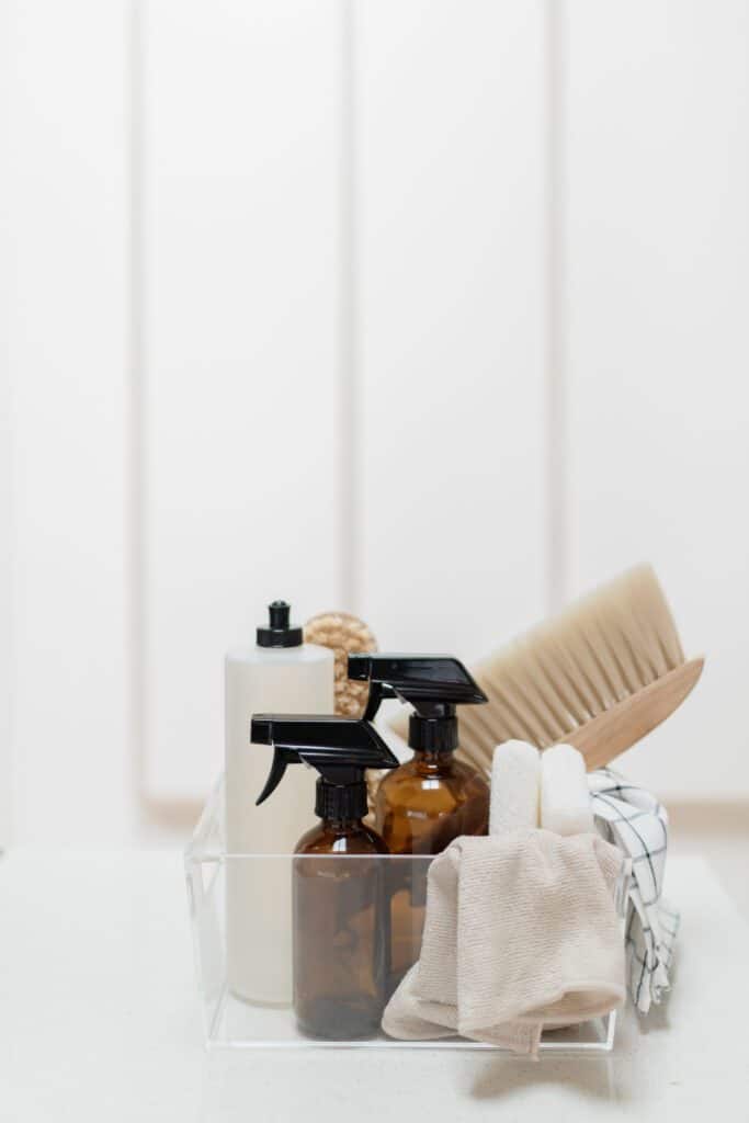 An organized clear box of cleaning products